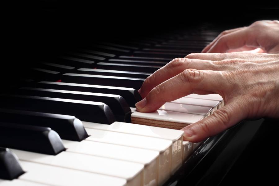 image of hands playing piano